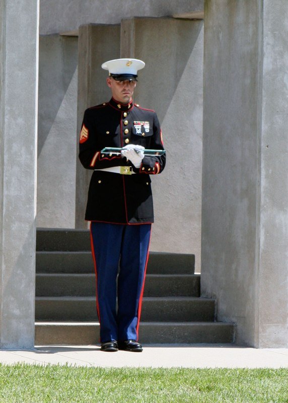 Soldier holding glass block next to the Patriots Peace Memorial