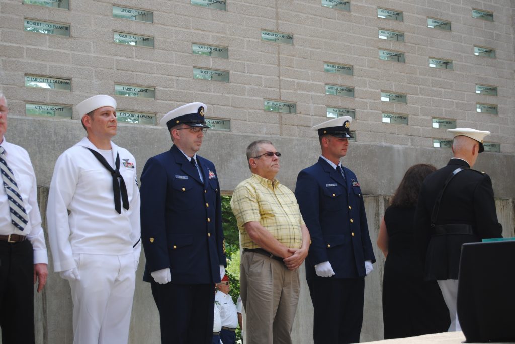 Family and soldiers standing in the memorial