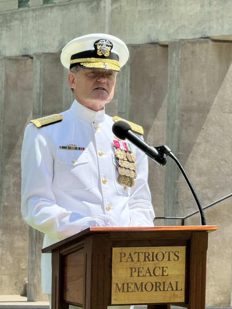 Man speaks during ceremony.